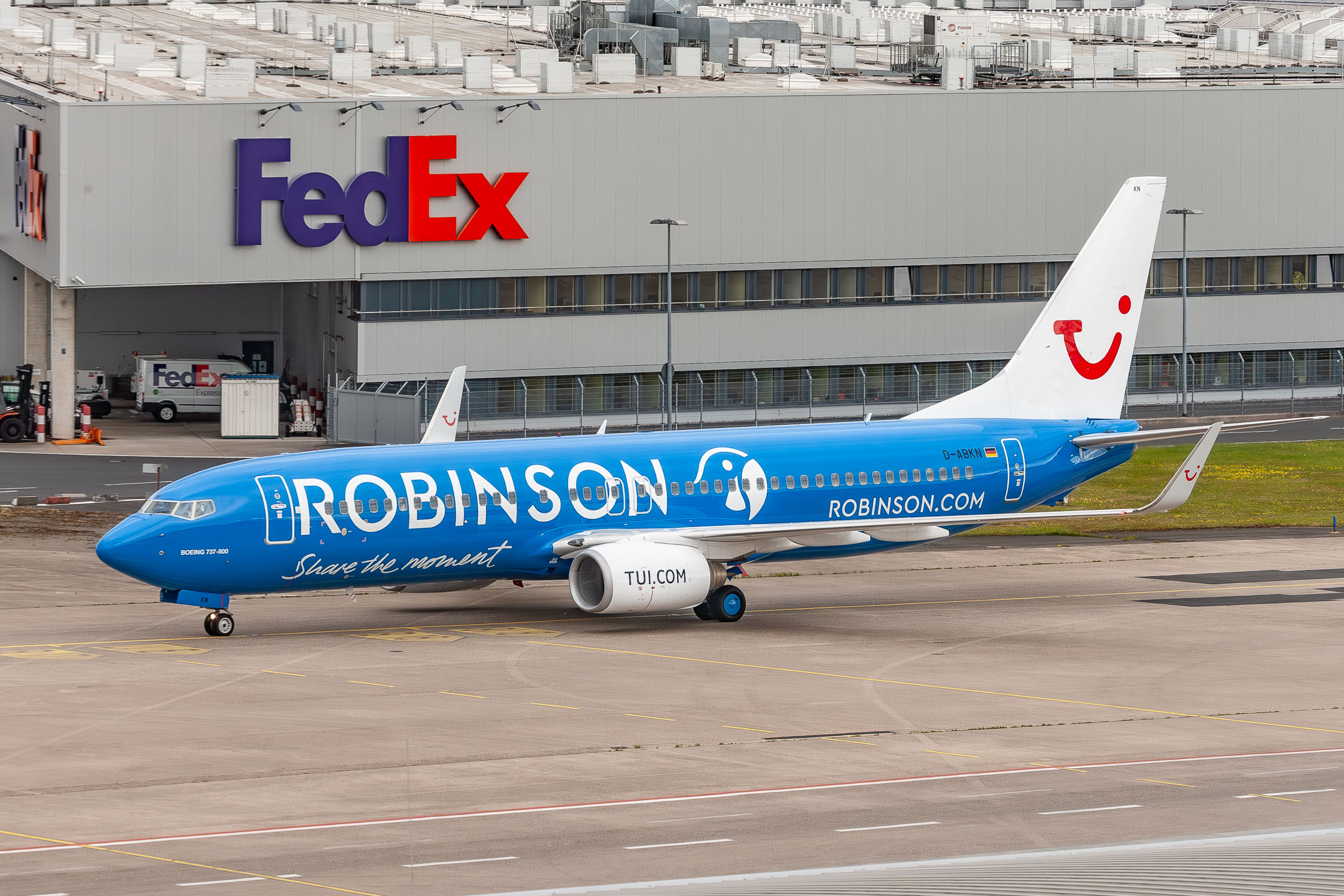 Tuifly Boeing 737-800 "D-ABKN" with the Robinson Club livery can be seen taxiing in front of the Fedex building at Köln Bonn Airport, May 2021