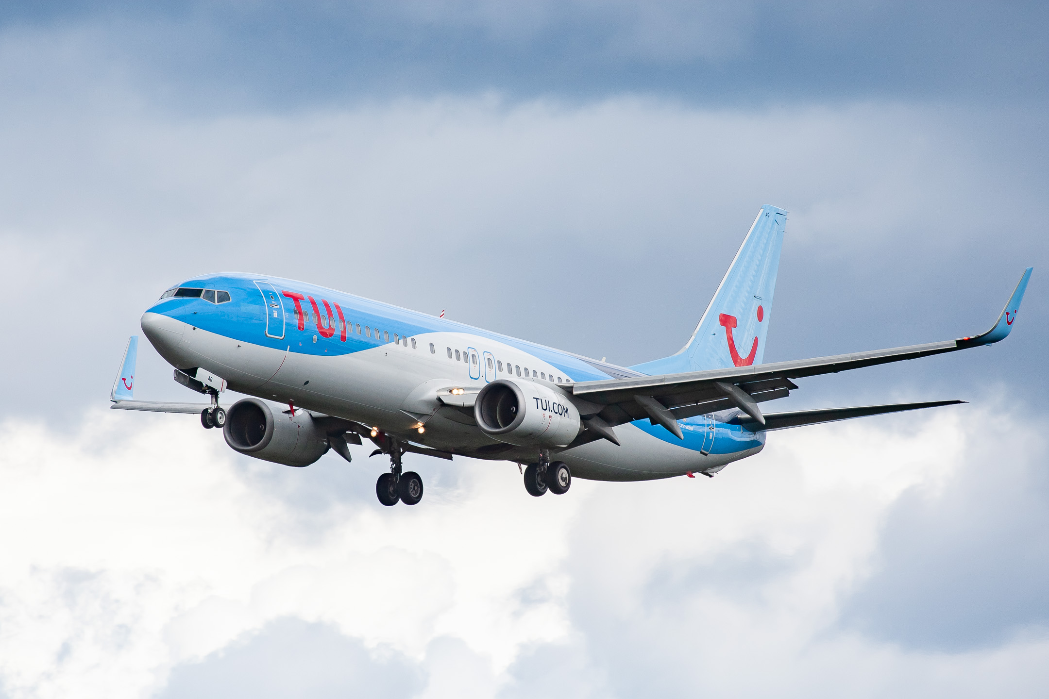 Tuifly Boeing 737-400 "D-ABAG" coming in on runway 25C at Frankfurt Airport on a cloudy summer afternoon, August 2021.