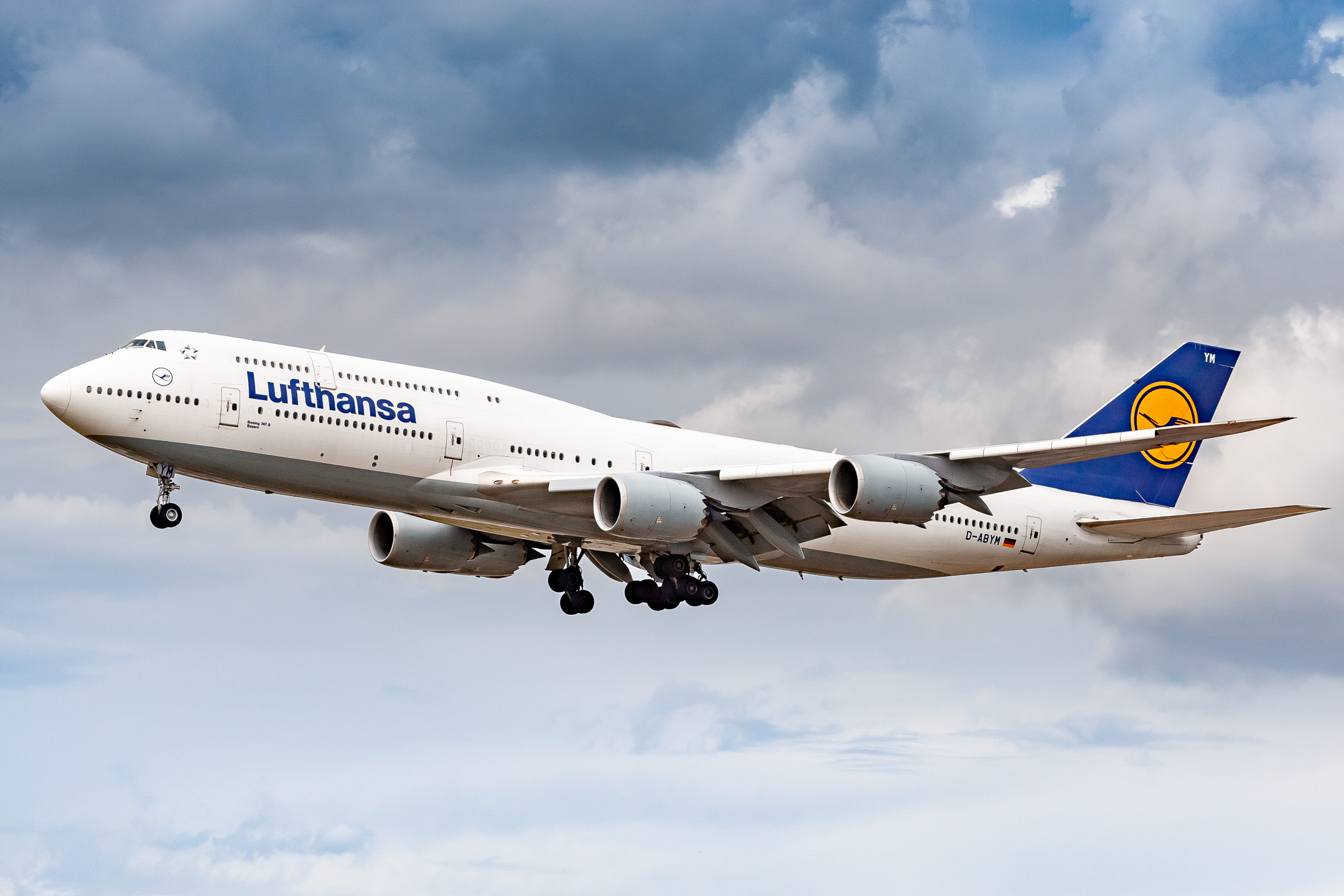 Lufthansa Boeing 747-8 "D-ABYN" coming in on runway 25C at Frankfurt Airport on a cloudy summer afternoon, August 2021.