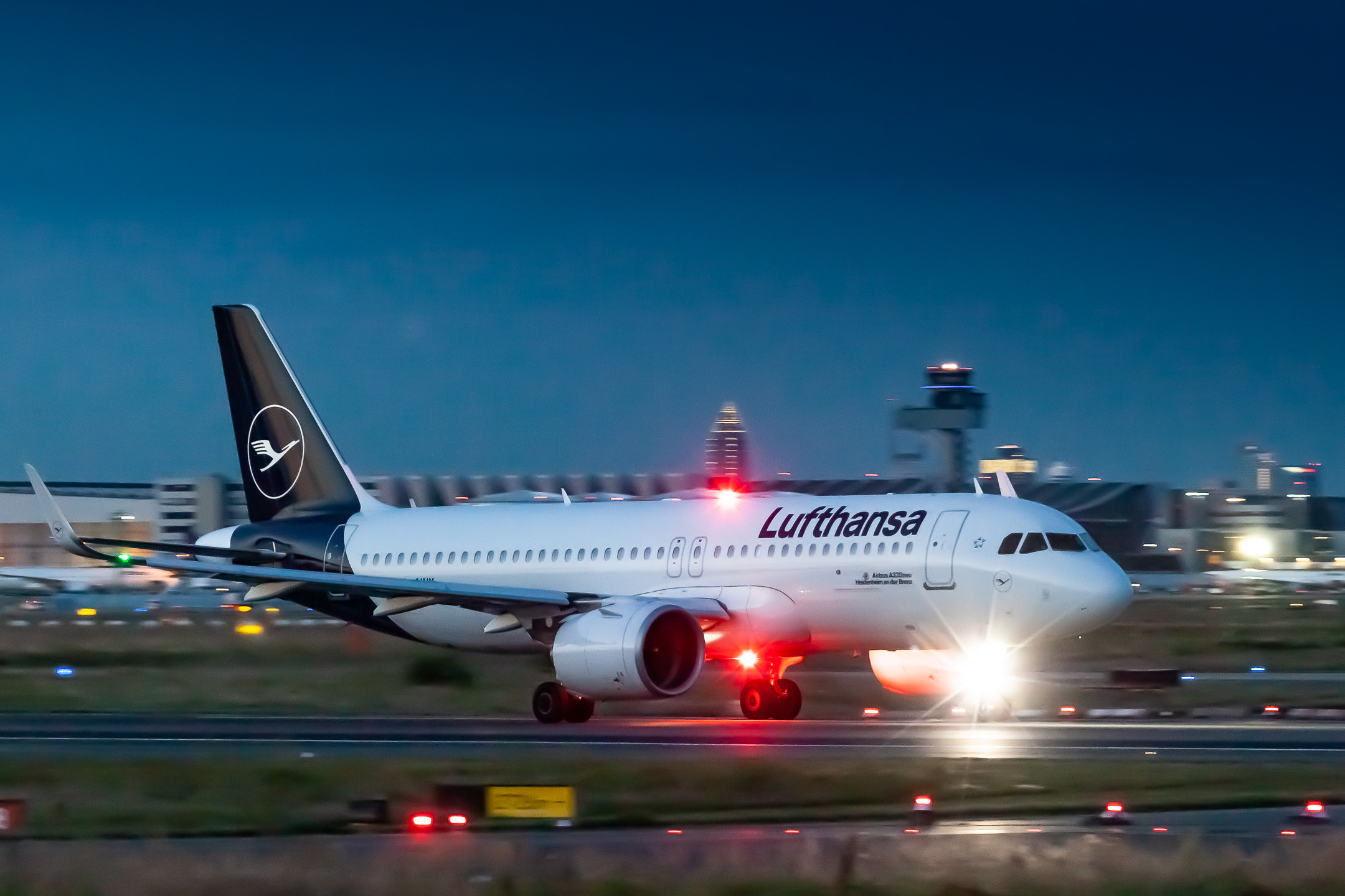 Lufthansa Airbus A320neo "D-AINK" accelerating on runway 18 at Frankfurt Airport on a warm summer evening, August 2021.