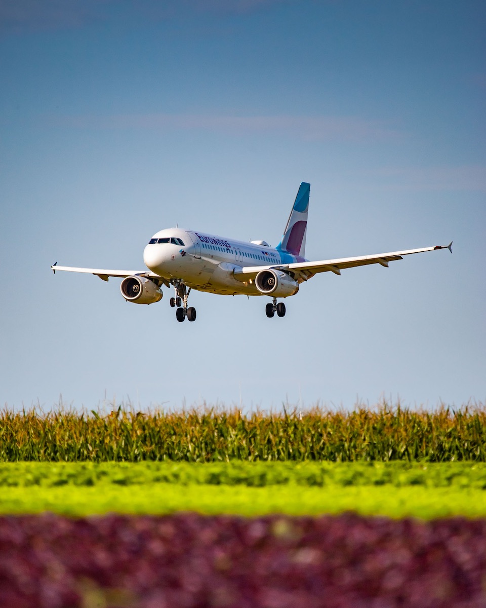 Eurowings Airbus A319-132 "D-AGWJ" over the Fildern fields on short final for runway 07 at Stuttgart Airport, August 2021