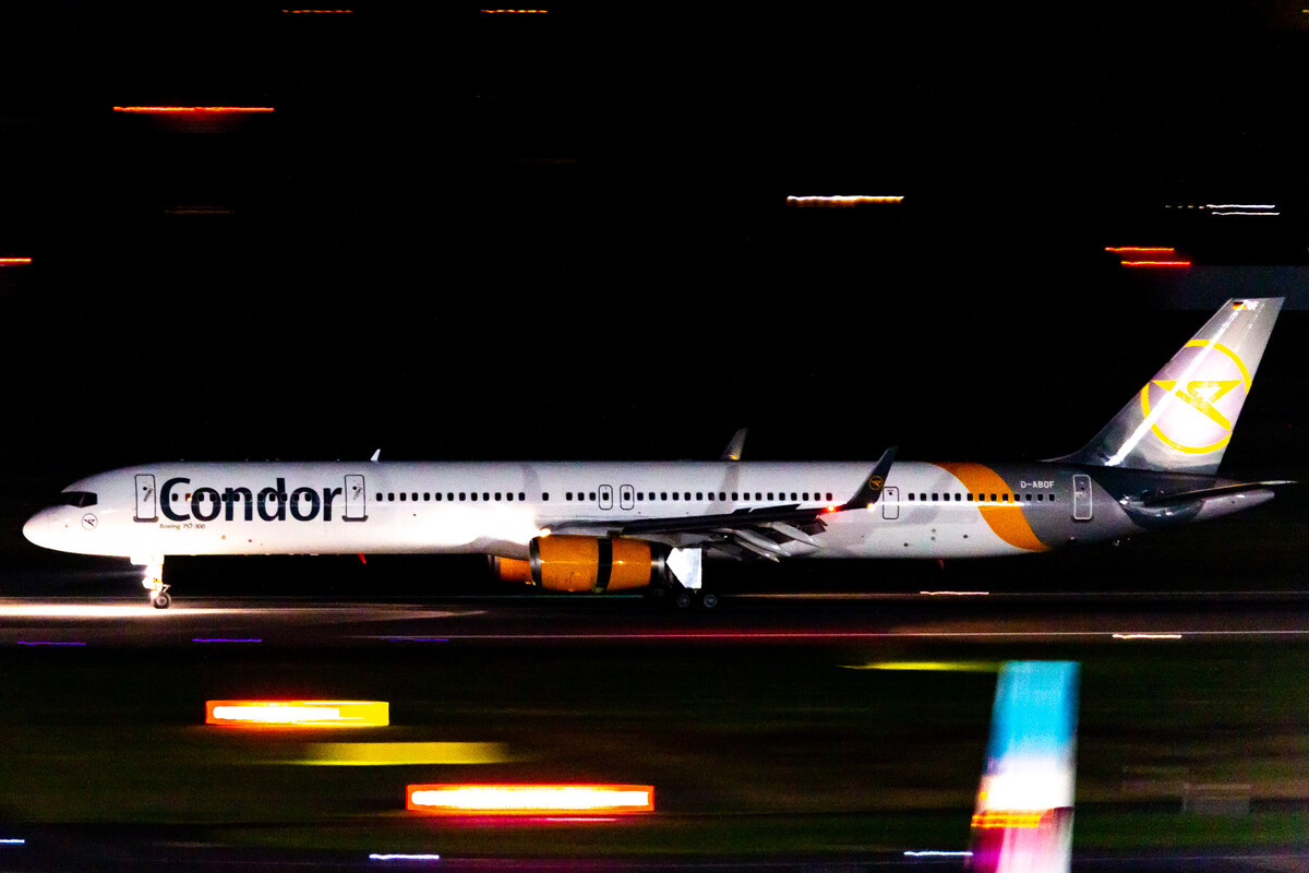 Condor Boeing 757-300 "D-ABOF" slowing down with activated reversers on runway 23 left at Düsseldorf Airport on a cold autumn night, October 2021