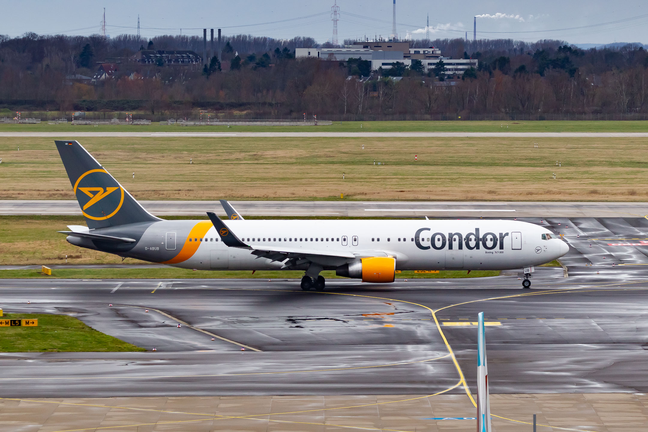 Condor Boeing 767-300 "D-ABUB" taxiing on taxiway Mike at Düsseldorf Airport on a cloudy winter afternoon, February 2022.