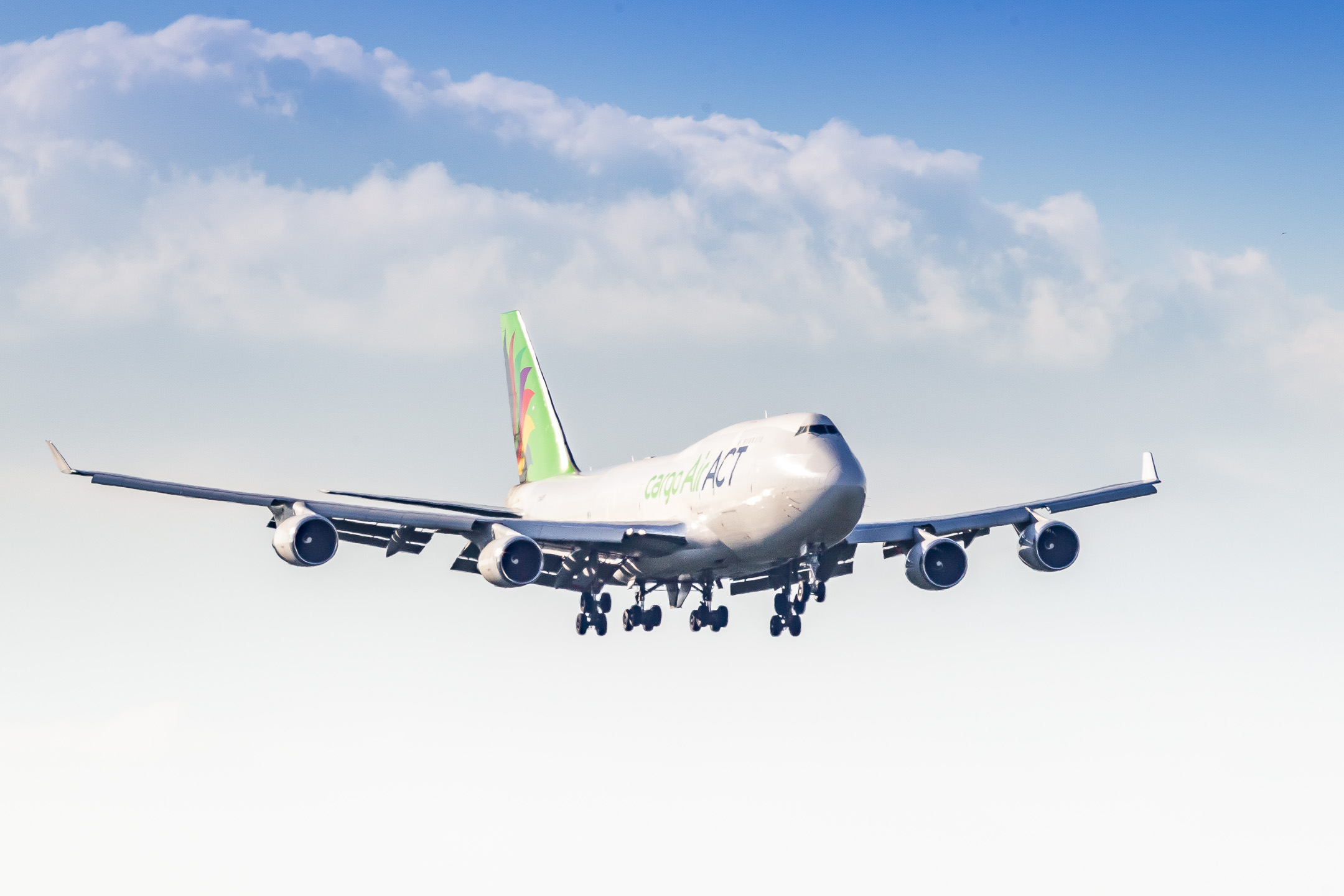 ACT Airlines Boeing 747-400 Freighter coming in on runway 14L at Cologne Bonn airport on a warm summer afternoon.