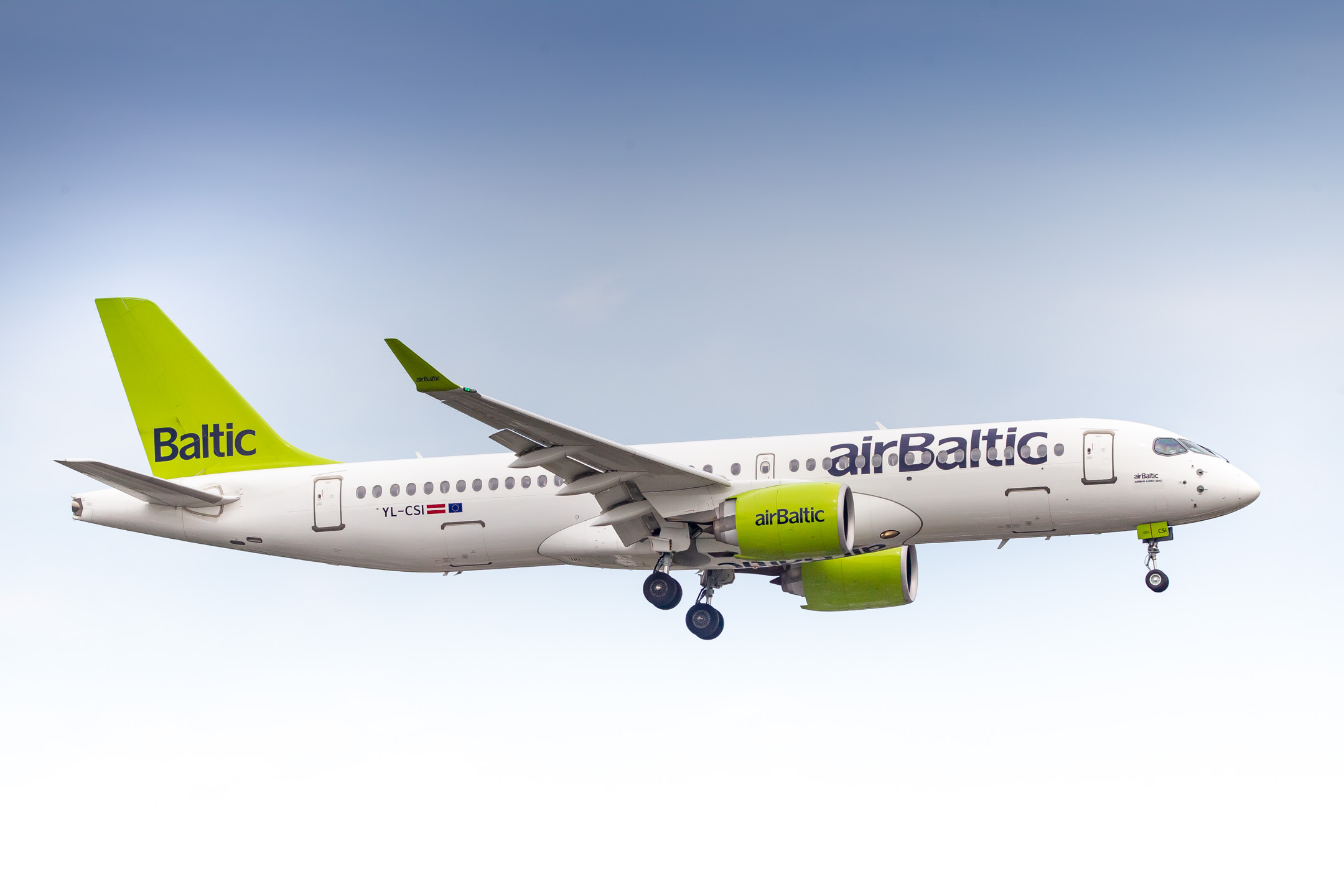 Air Baltic Airbus A220-300 (Registration "YL-CSI") arriving at Düsseldorf Airport on a cloudy summer afternoon, June 2022