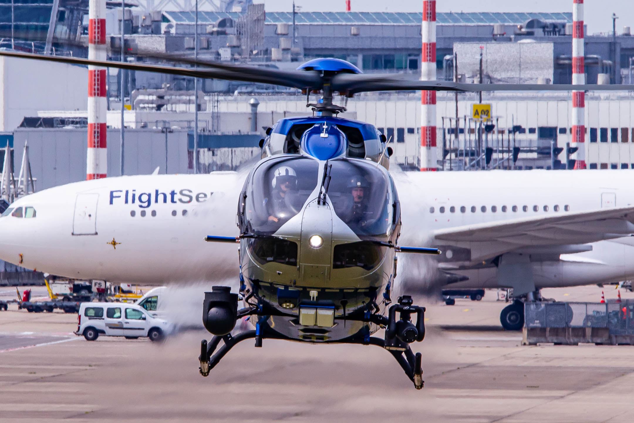 Airbus Helicopters H145 of the Polizeifliegerstaffel Düsseldorf hovering at the ramp of its hangar at Düsseldorf Airport on a warm summer afternoon, July 2022