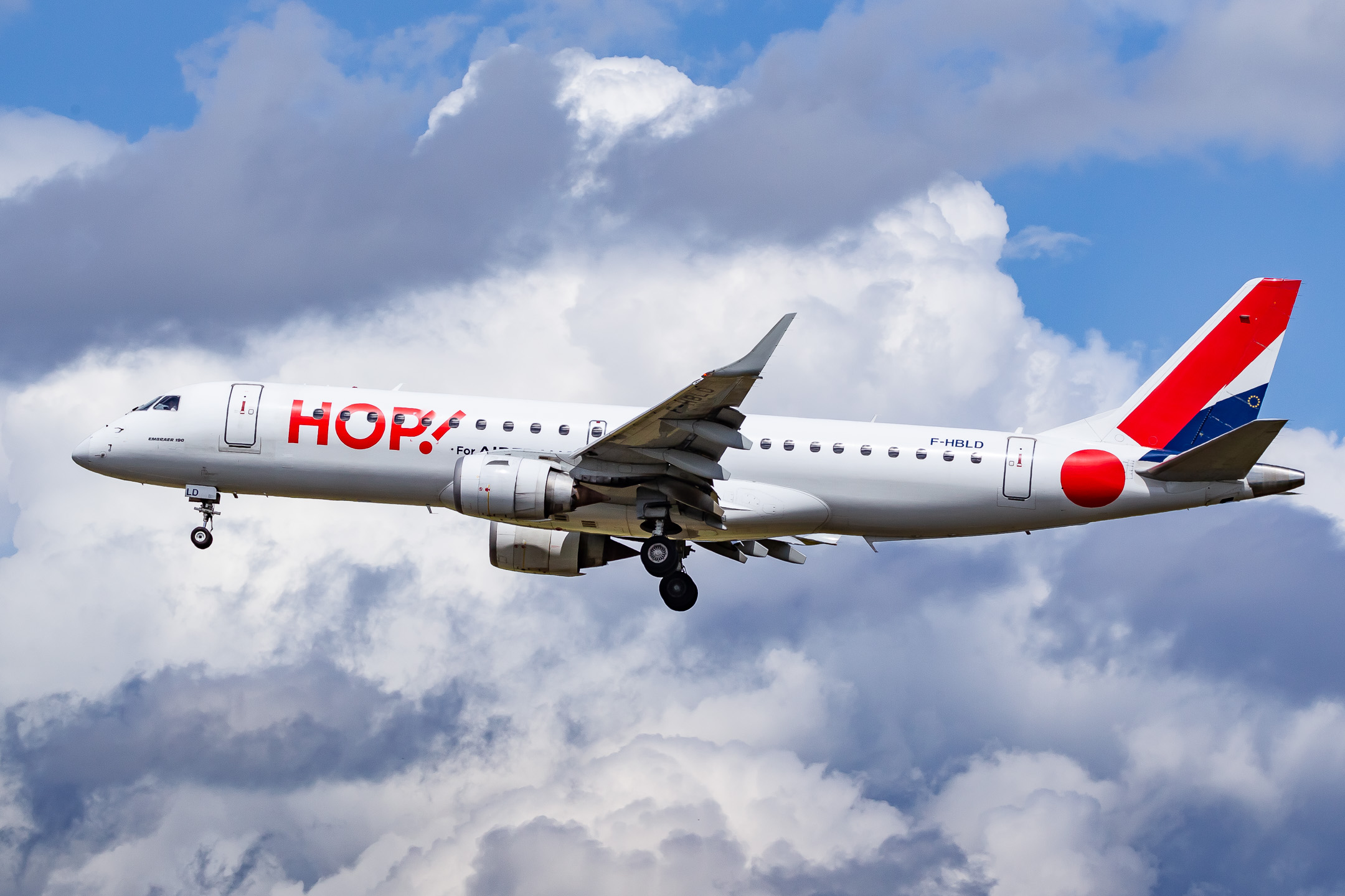 Air France Hop Embraer ERJ-190 "F-HBLD" on short final for runway 23L at Düsseldorf Airport on a cloudy summer afternoon, June 2022