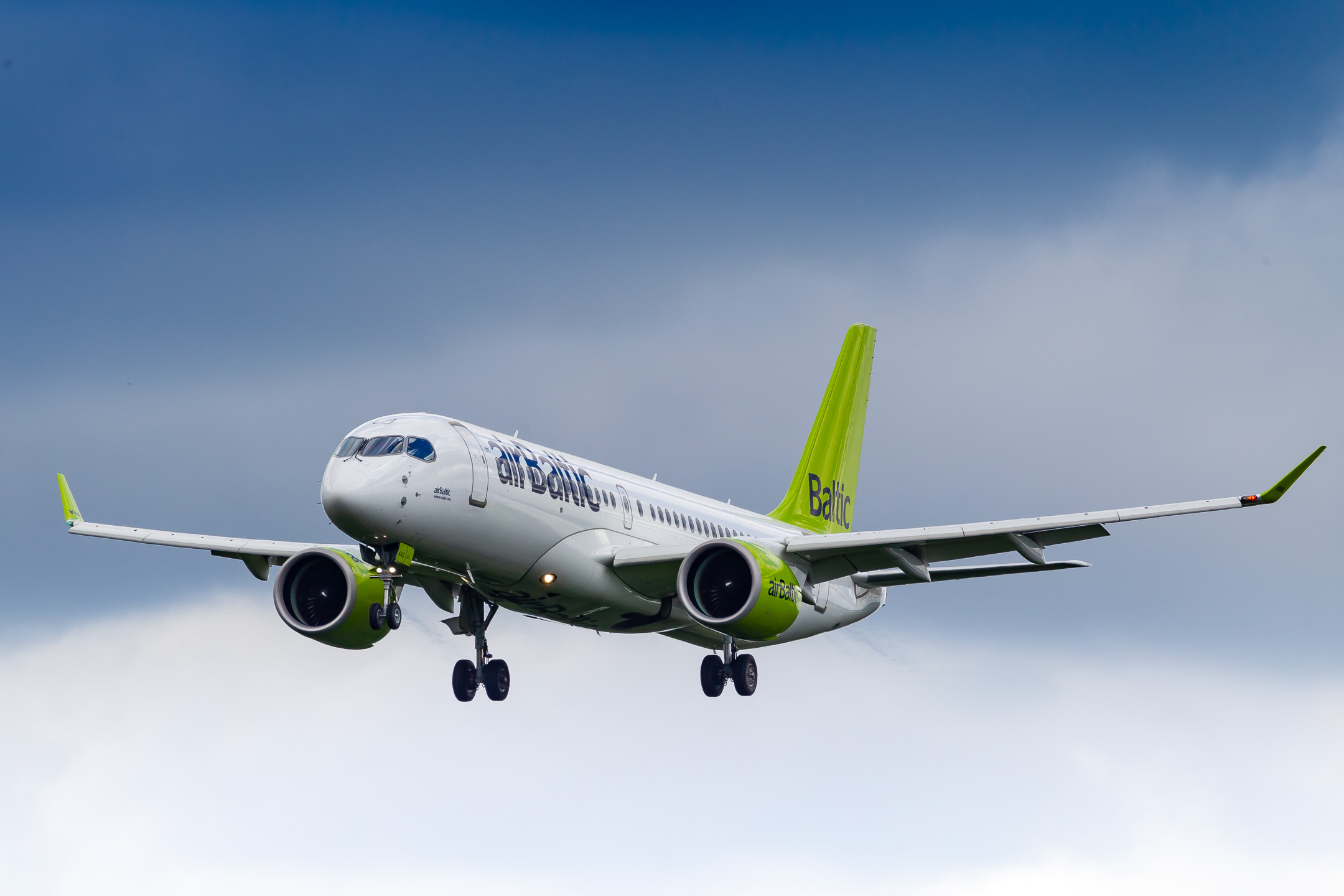 Air Baltic Airbus A220-300 "YL-AAQ" arriving at Düsseldorf Airport short before a storm rushing over the airport, June 2022.