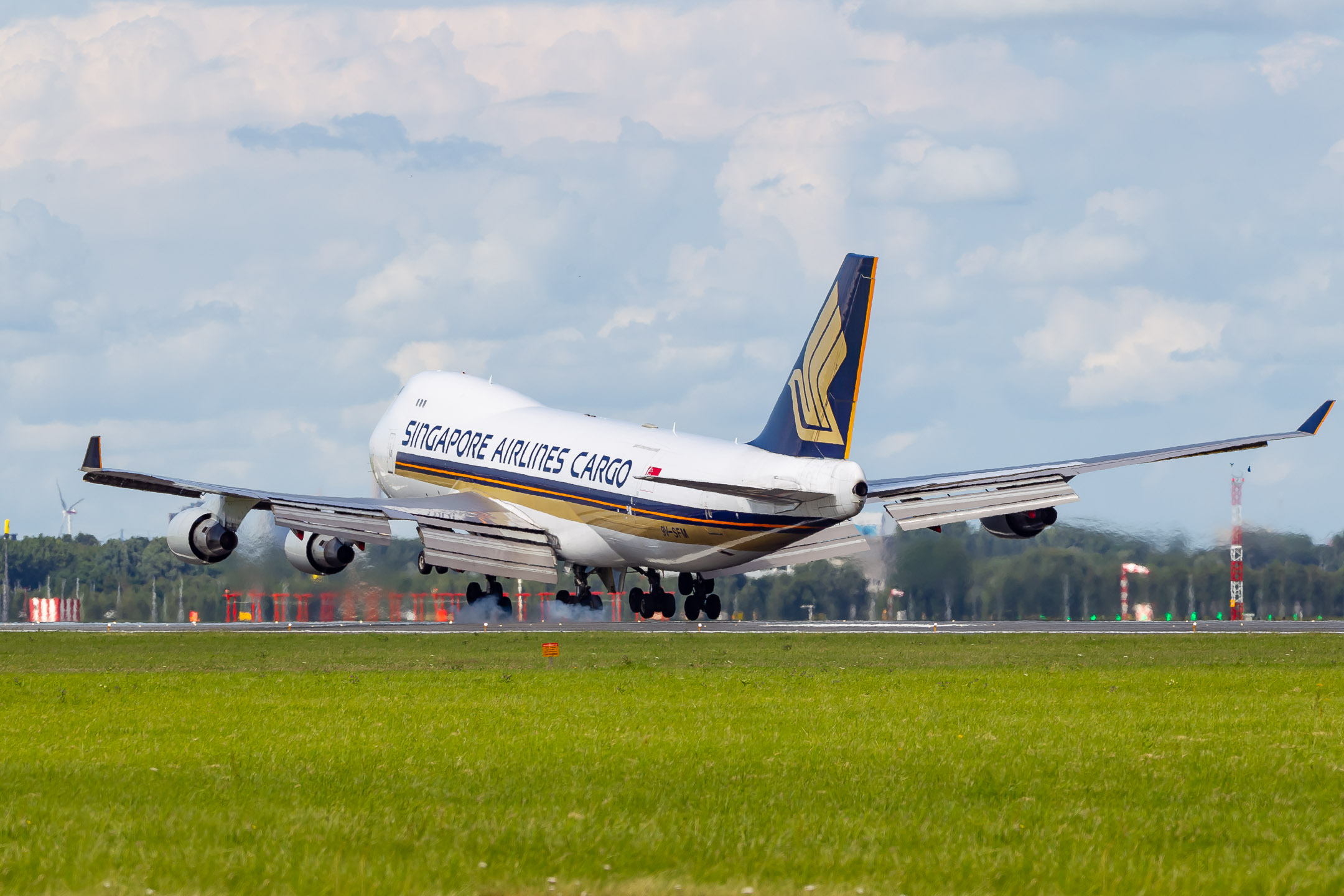 Singapore Airlines Boeing 747-400F "9V-SFM" during touchdown on runway 18 right at Amsterdam Schiphol Airport, called the "Polderbaan", on a warm summer day, July 2022. 