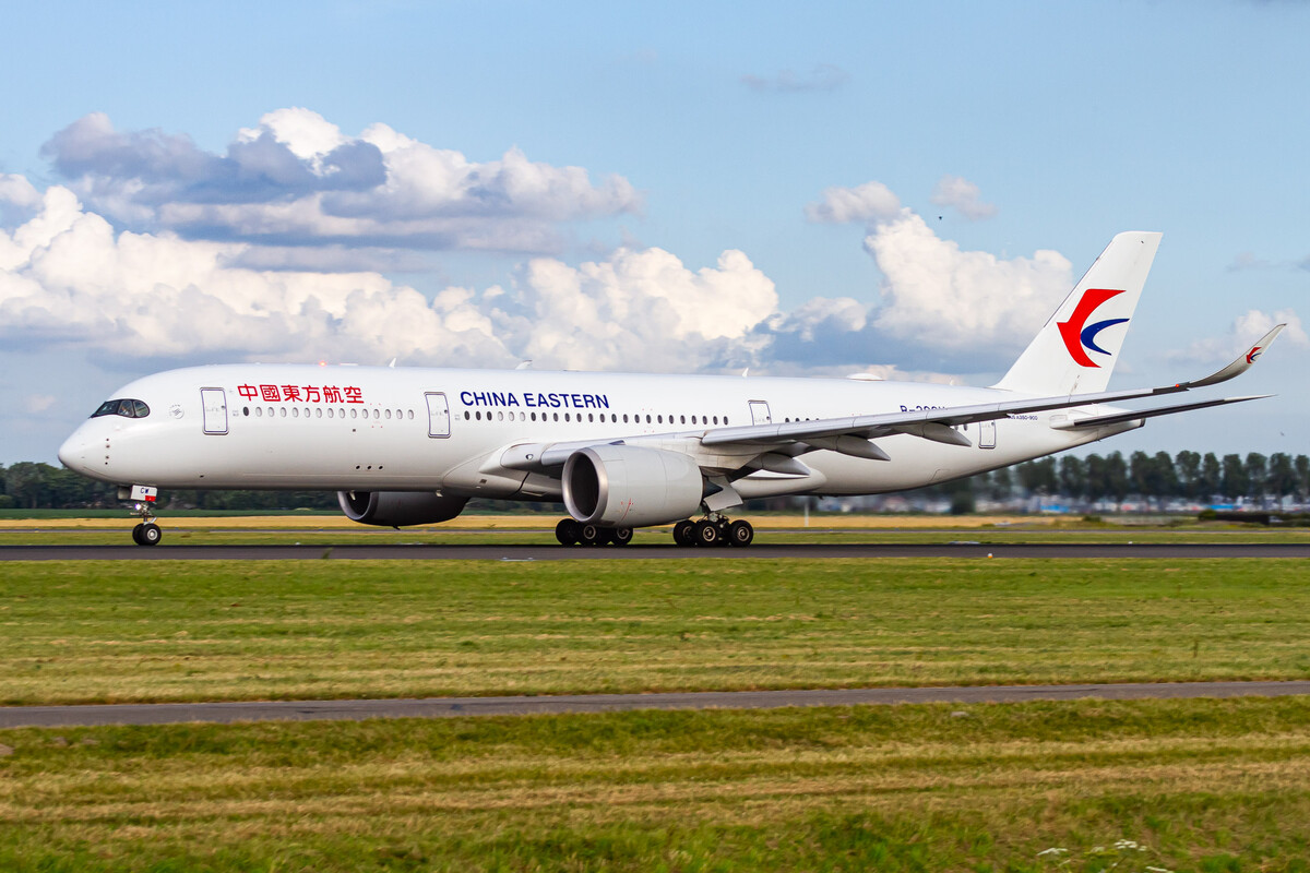 China Eastern Airbus A350-941 "B-30CW" accelerating on the Polderbaan at Amsterdam Schiphol Airport on a hot summer evening, July 2022.