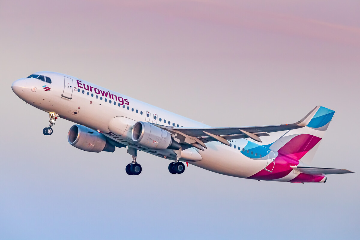 Eurowings Airbus A320-200 "D-AEWT" taking off in the first morning light from runway 14 left at Köln Bonn Airport on a very early summer morning, August 2022