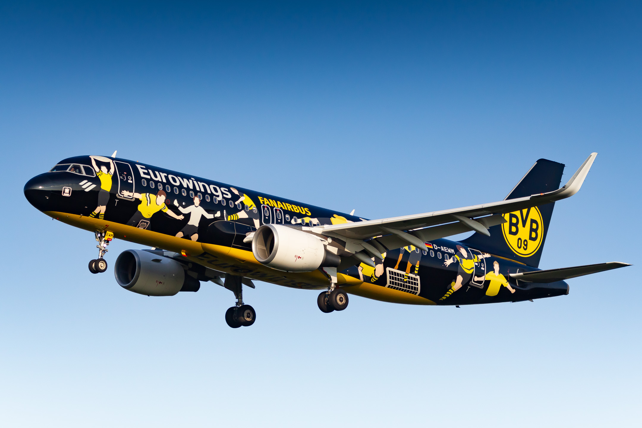 The beautiful "Borussia Dortmund Fanairbus" Airbus A320-200 "D-AEWM" of Eurowings on short final for runway 32R at Köln Bonn Airport on a warm late summer evening, September 2022.