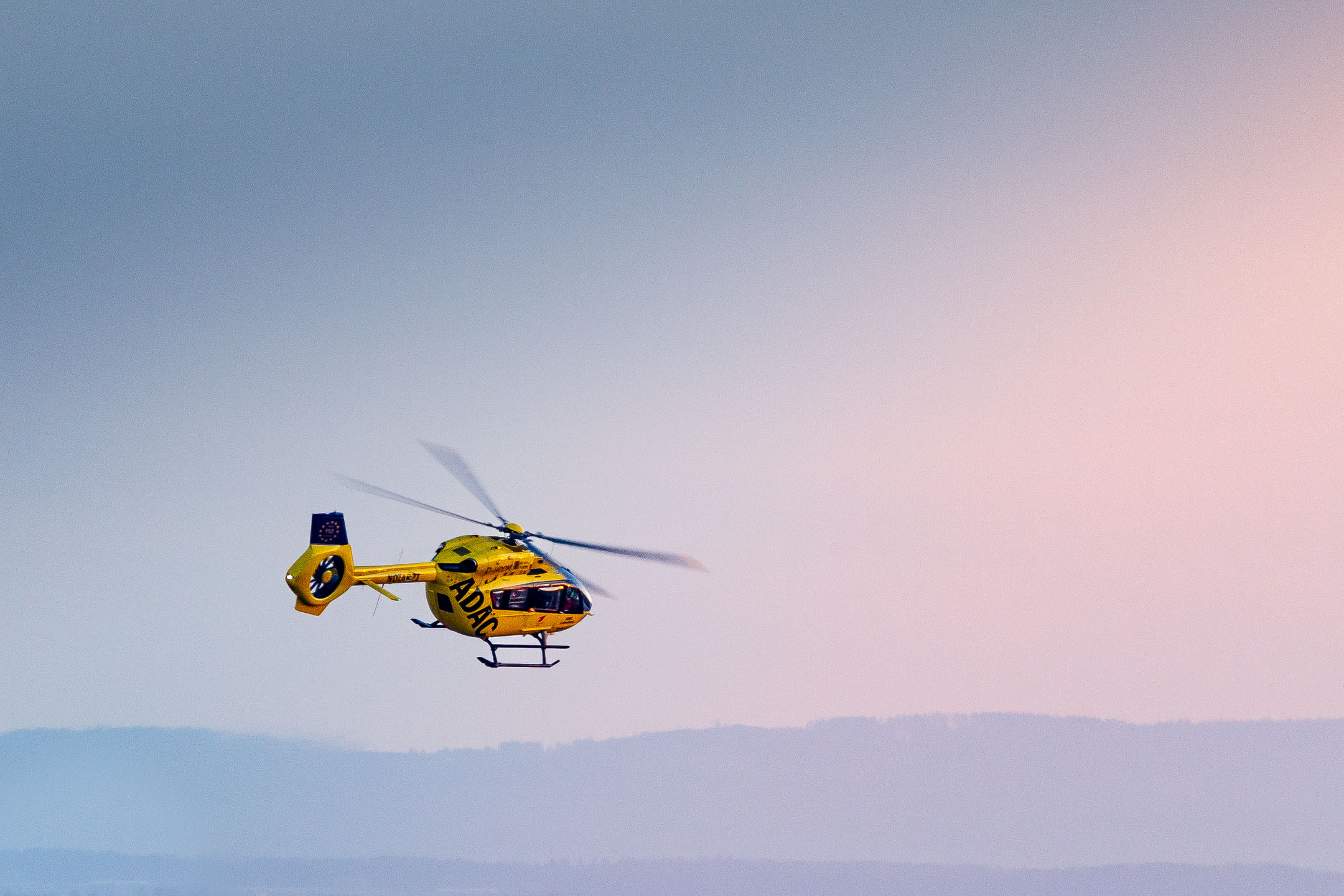 The Eurocopter EC145 "D-HDOM" of ADAC Luftrettung departs from it's homebase Cologne Bonn Airport on a hazy autumn evening.