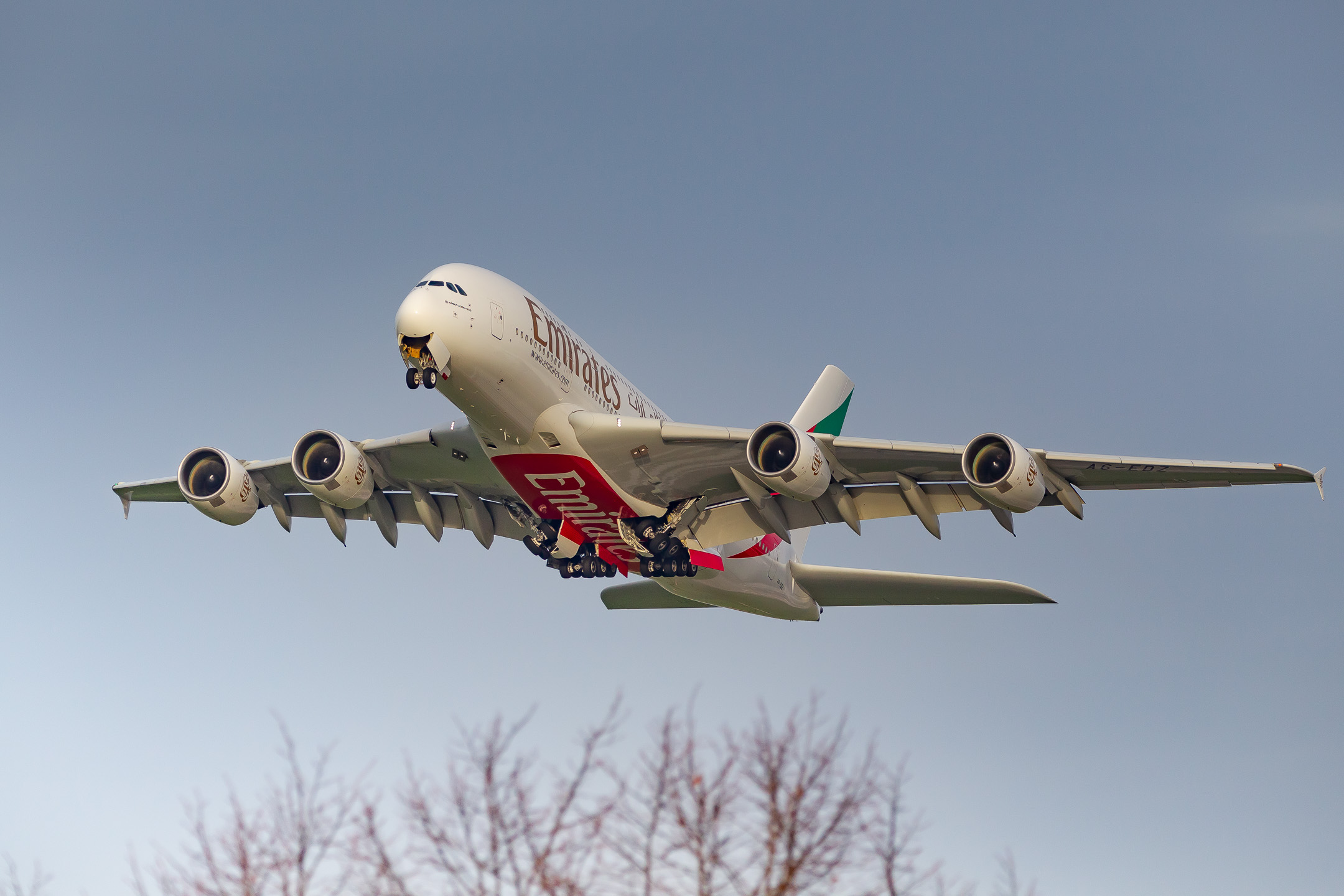 Emirates Airbus A380-800 "A6-EDZ" climbing our of runway 23L at Düsseldorf Airport on a cold autumn day, November 2022.