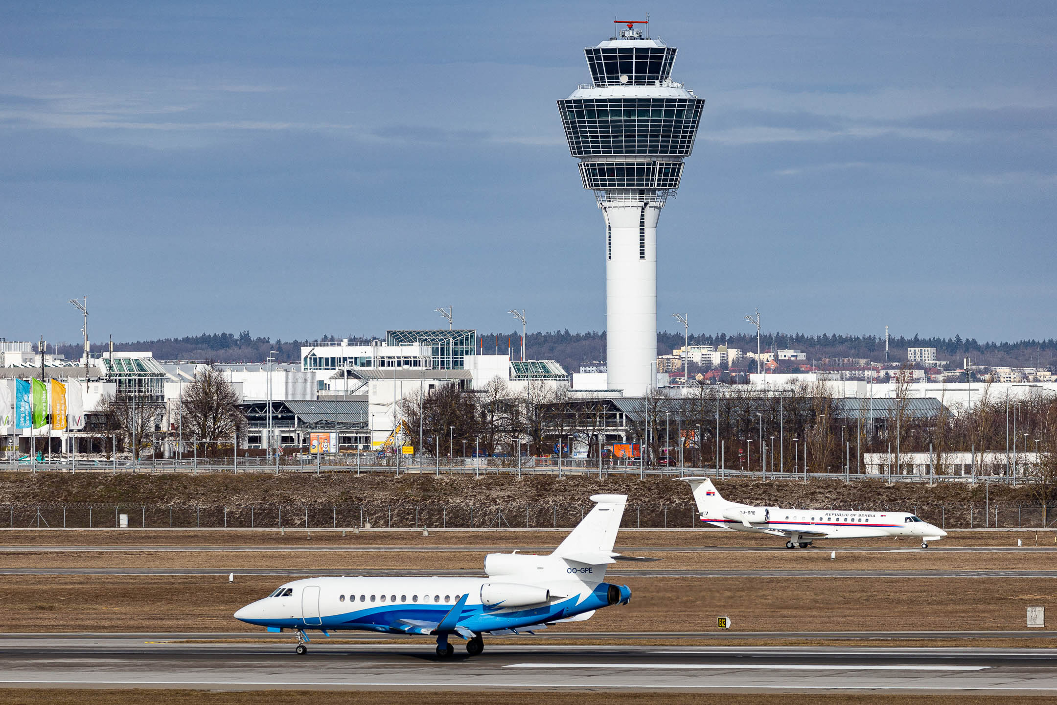 During the Munich Security Conference, many governmental flights arrived and departed from Munich Airport. Picture shows a Belgium Dassault Falcon 900LX (callsign "OO-GPE") and a Croatian Embraer ERJ-135 (YU-SRB) in one shot on February 17th, 2023.