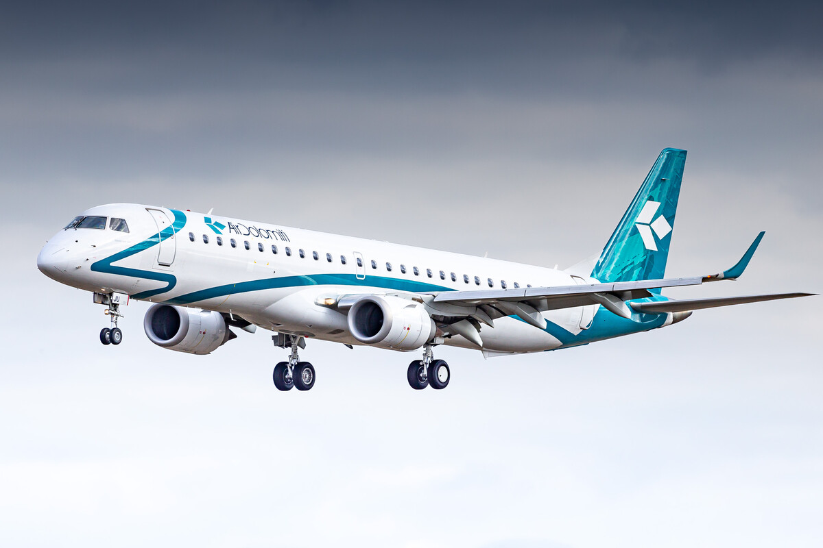 Air Dolomiti Embraer ERJ-195 "I-ADJU" right before touchdown on runway 26 left at München Airport on a windy winter afternoon, February 2023