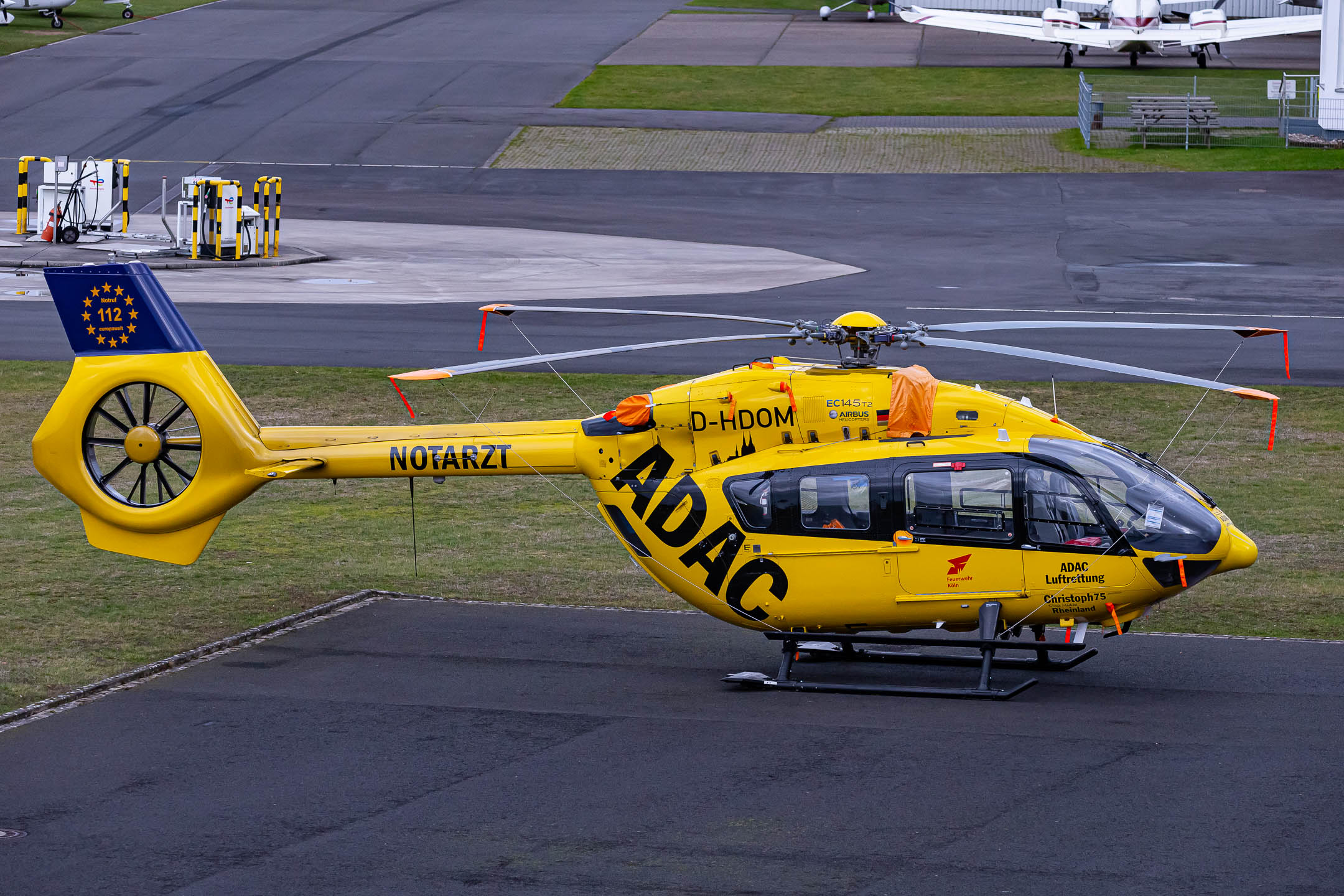 ADAC Luftrettung Eurocopter EC145 T2 "D-HDOM" parked at Bonn Hangelar Airport in front of the ADAC maintenance facility, March 2023.