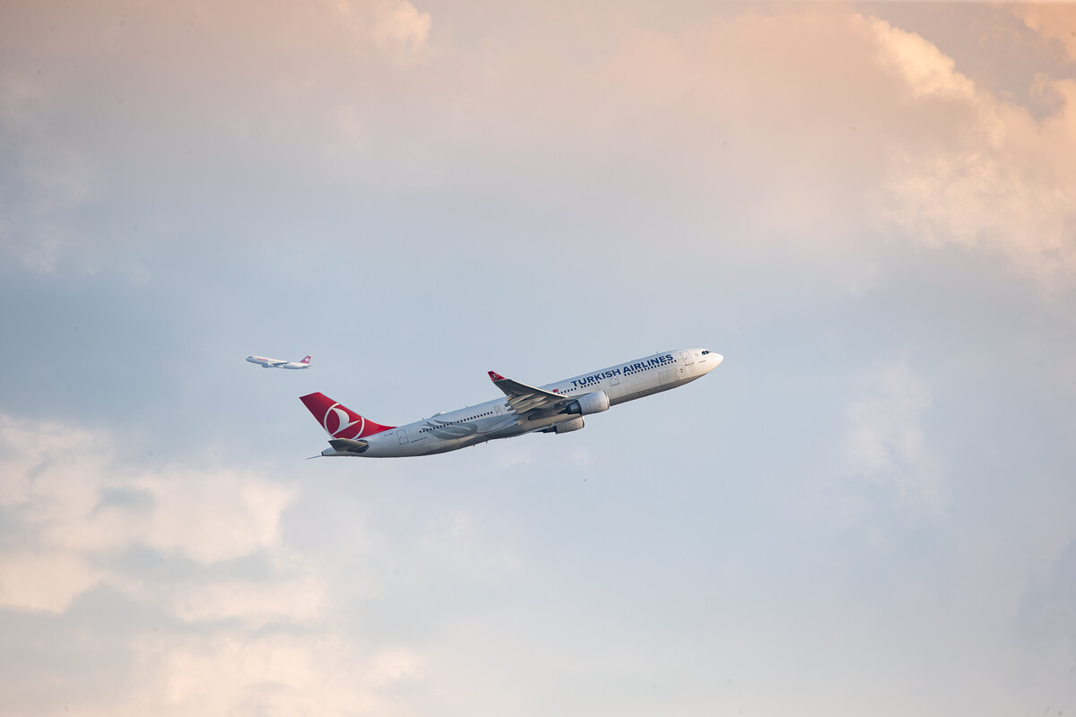 Turkish Airlines Airbus A330-300 "TC-JOF" taking off from runway 28 at Zürich Kloten Airport while in the background another aircraft can be seen on its departure route, July 2024