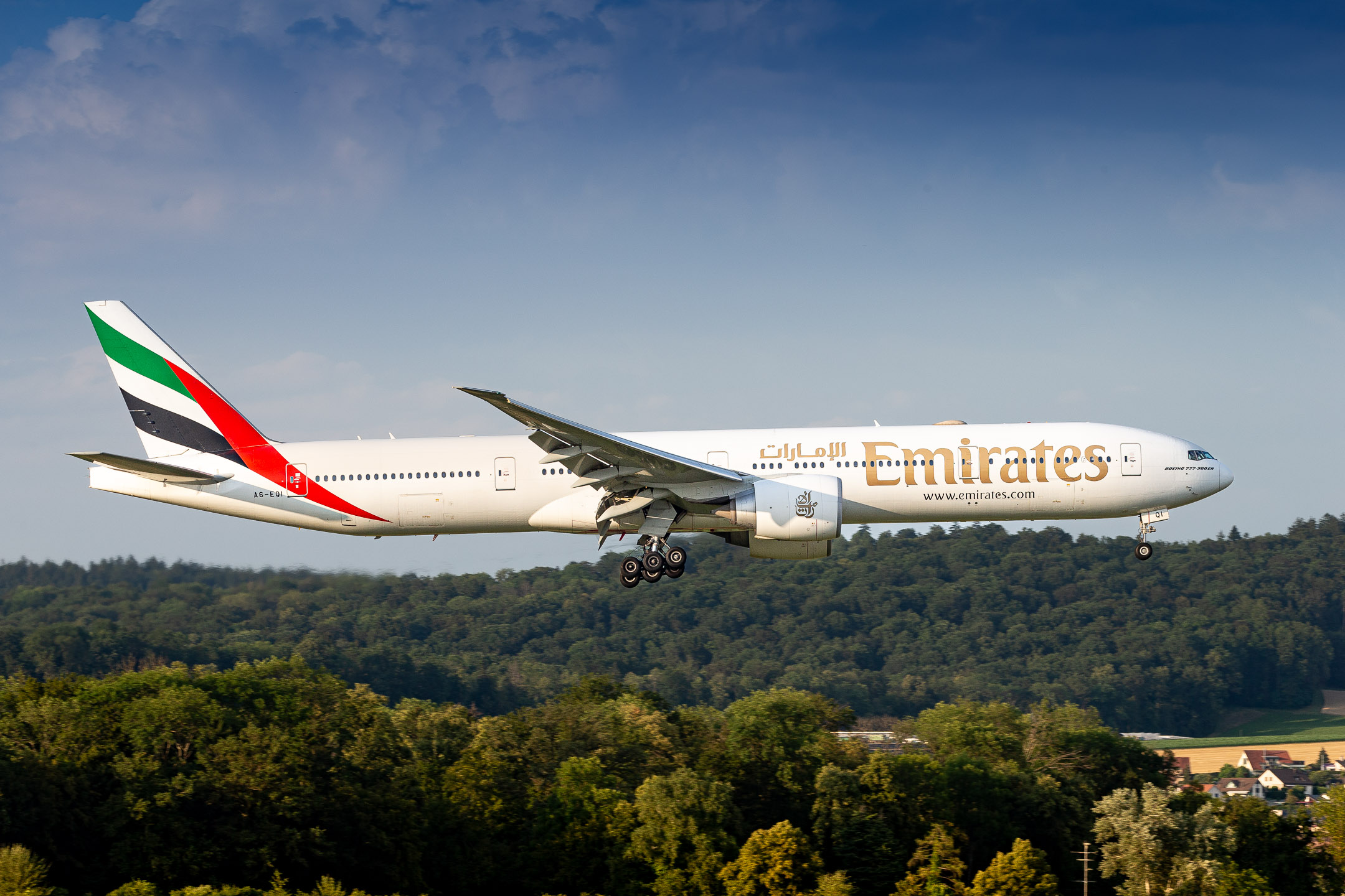 Emirates Boeing 777-300ER "A6-EQI" right before touchdown on runway 14 at Zürich Kloten Airport, July 2023