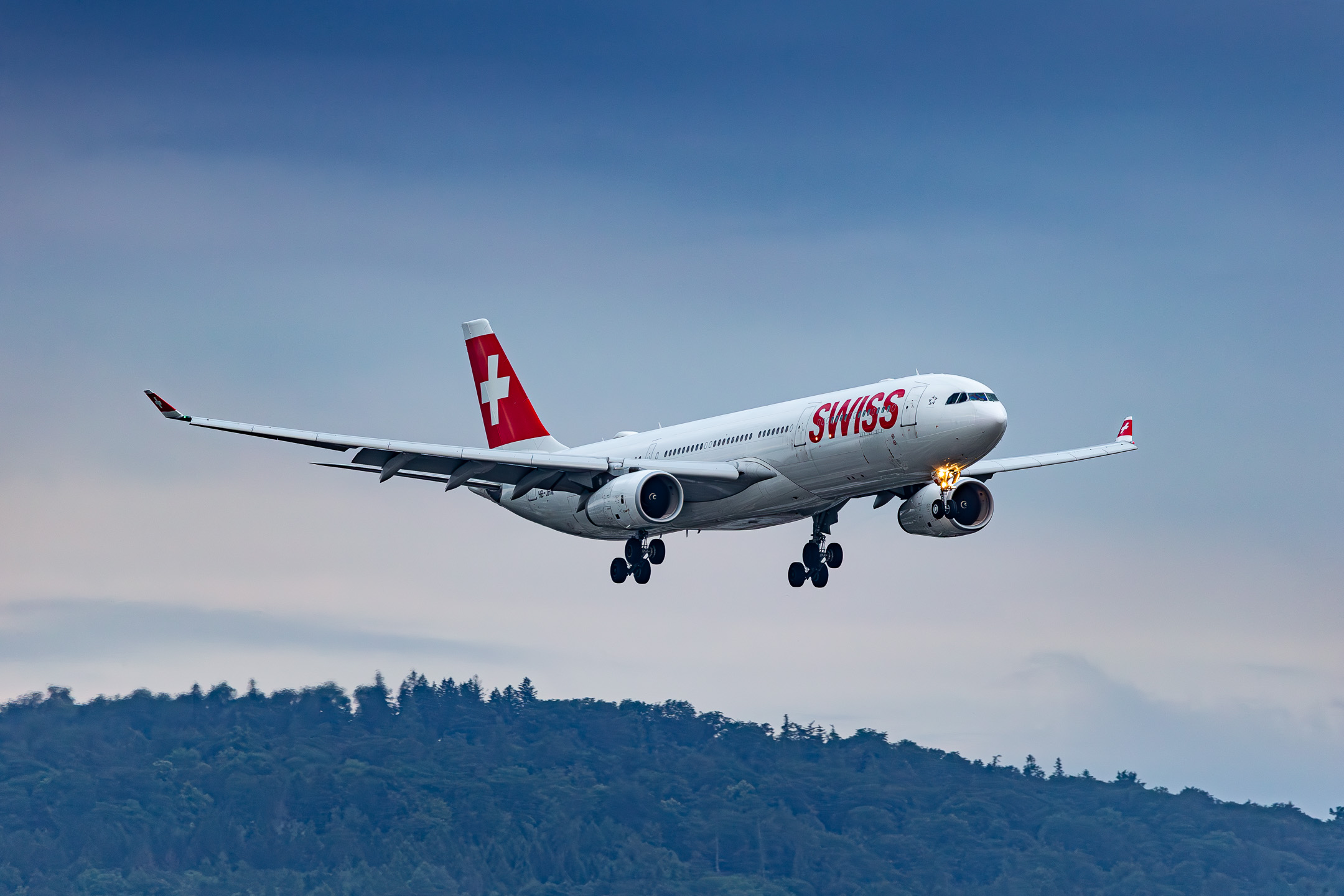 Swiss Airbus A330-300 ("HB-JHM") on short final for runway 34 at Zürich Airport on a cloudy summer morning, July 2023