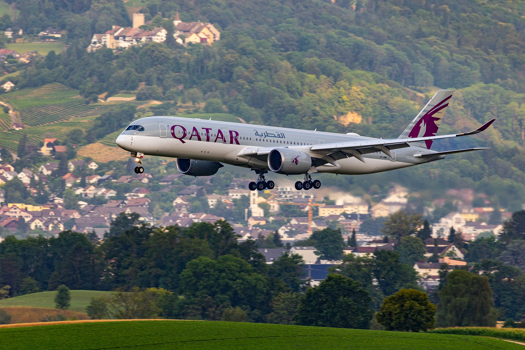 Qatar Airways Airbus A350-900 "A7-AMF" on short final for runway 14 at Zürich Airport on a early summer morning, July 2023.