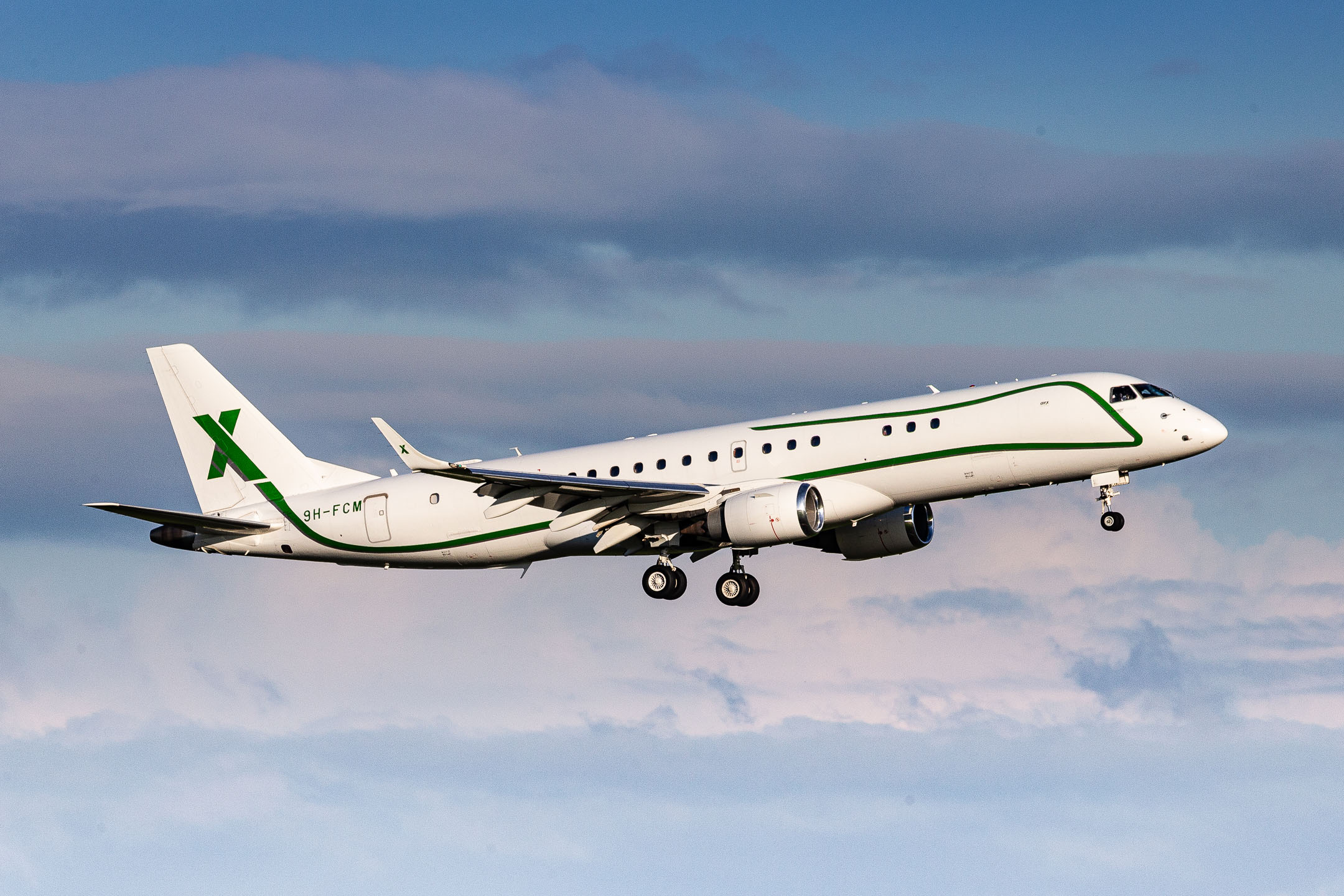 AIR X Charter Embraer Lineage 1000 (ERJ-190-100 ECJ) "9H-FCM" on short final for runway 23L at Düsseldorf Airport on a sunny summer evening, August 2023