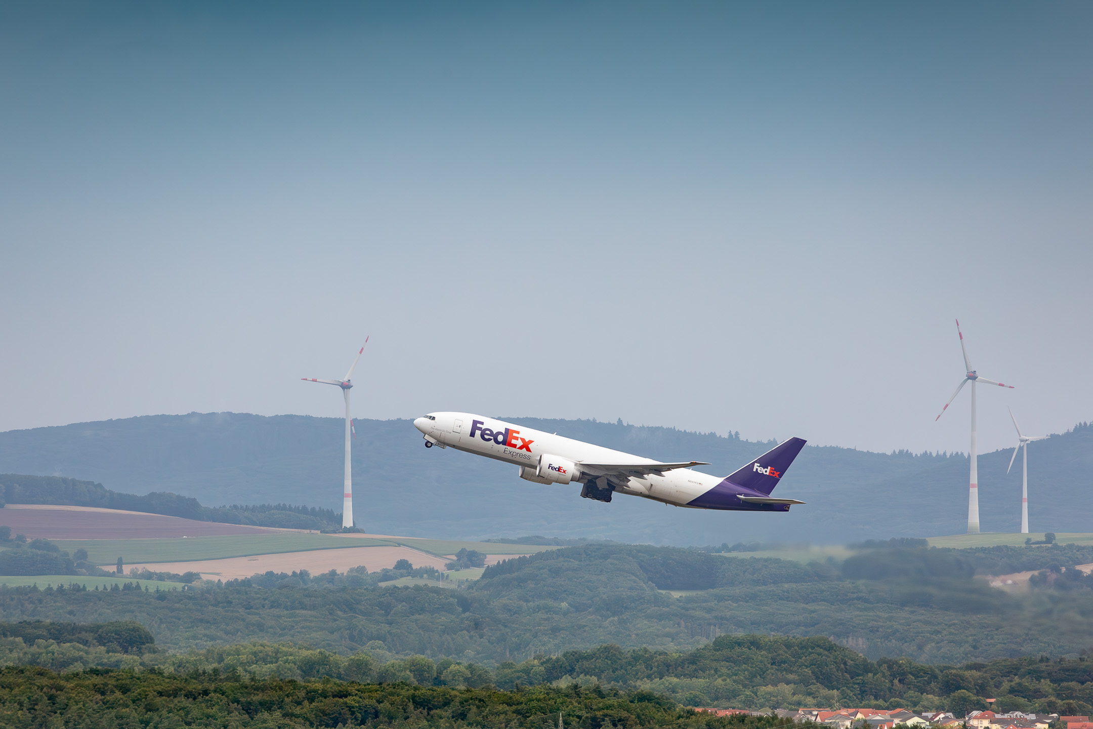 Fedex Boeing 777F taking off from Ramstein Air Base on a hazy Sunday afternoon, July 2025.