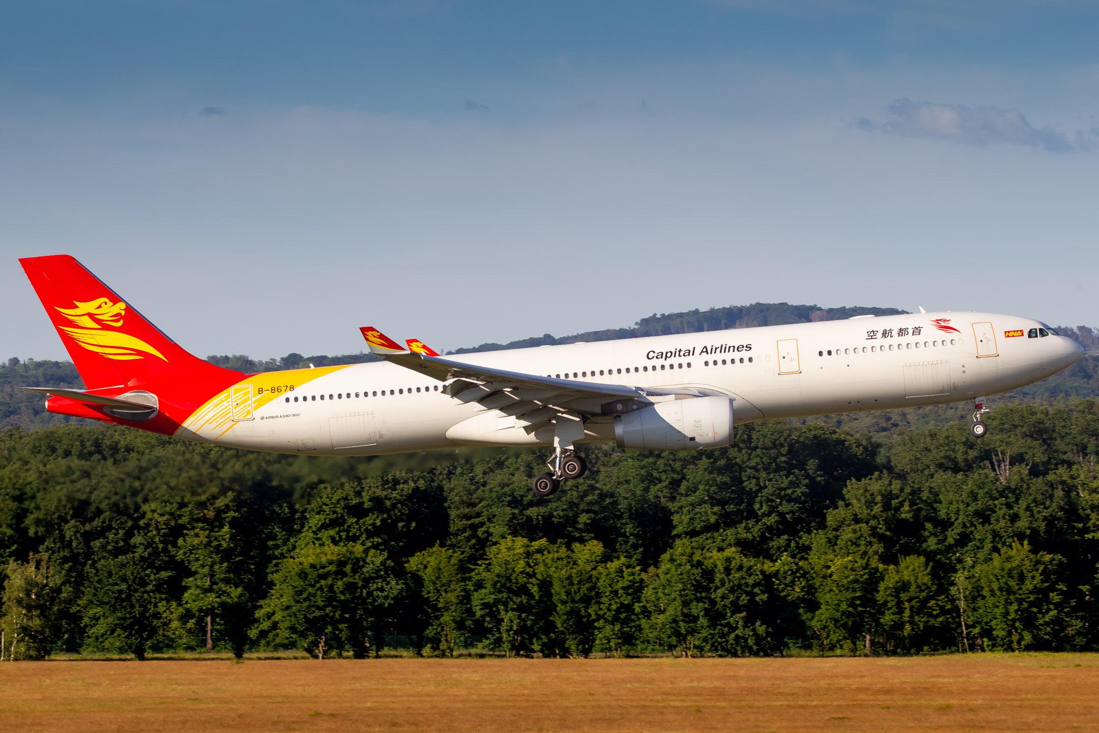 Capital Airlines Airbus A330-300 "B-8678" right before touchdown on runway 14L at Köln Bonn Airport, June 2022.